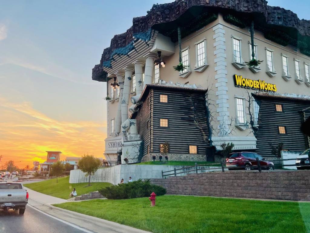 WonderWorks Branson’s upside-down building glowing at sunset.